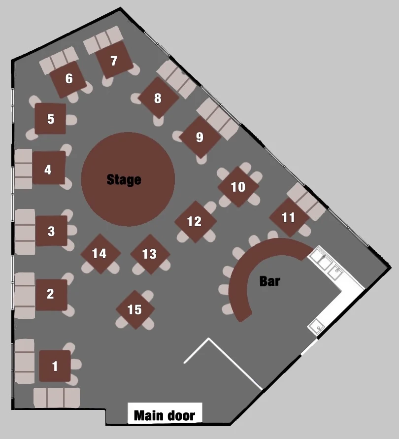 Floor plan of Élite Saigon: a circular stage at the centre of the room with fifteen numbered tables arranged around it, banquette seating along the west and north walls, a curved bar with stools to the south-east, and the main door at the bottom of the plan.